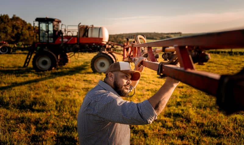 Operador de máquinas agrícolas trabalhando em puverizador